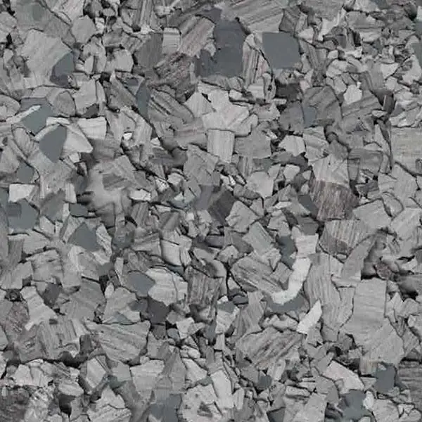 A textured surface composed of various irregularly-shaped gray fragments, resembling a complex mosaic or stone pattern with a rugged appearance.