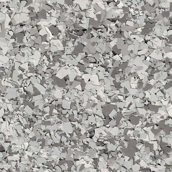 A textured surface featuring numerous irregular, angular gray pieces scattered closely together, creating a fragmented mosaic-like pattern without any discernible landmarks.