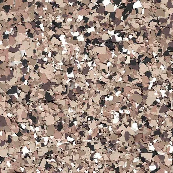 A textured surface featuring an abstract pattern of scattered multi-colored flakes in shades of brown, beige, black, and white.
