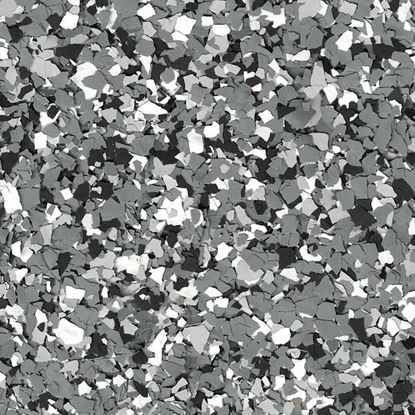 Close-up of a textured surface with small, irregularly shaped pieces in shades of gray, white, and black, creating a speckled pattern.