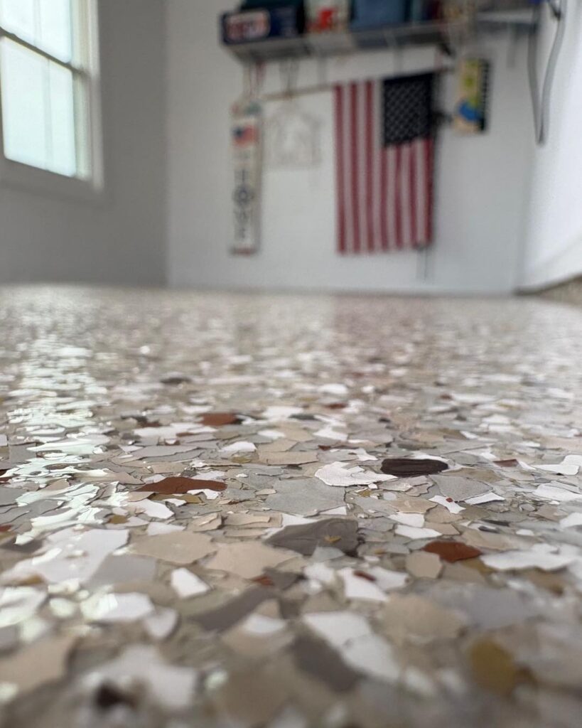 A terrazzo floor with a blurred background showing a U.S. flag, shelves, and items in a brightly lit room.
